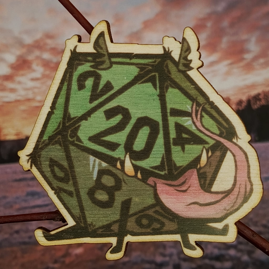 Brož s dvacetistěnným symbolem volby a náhody.