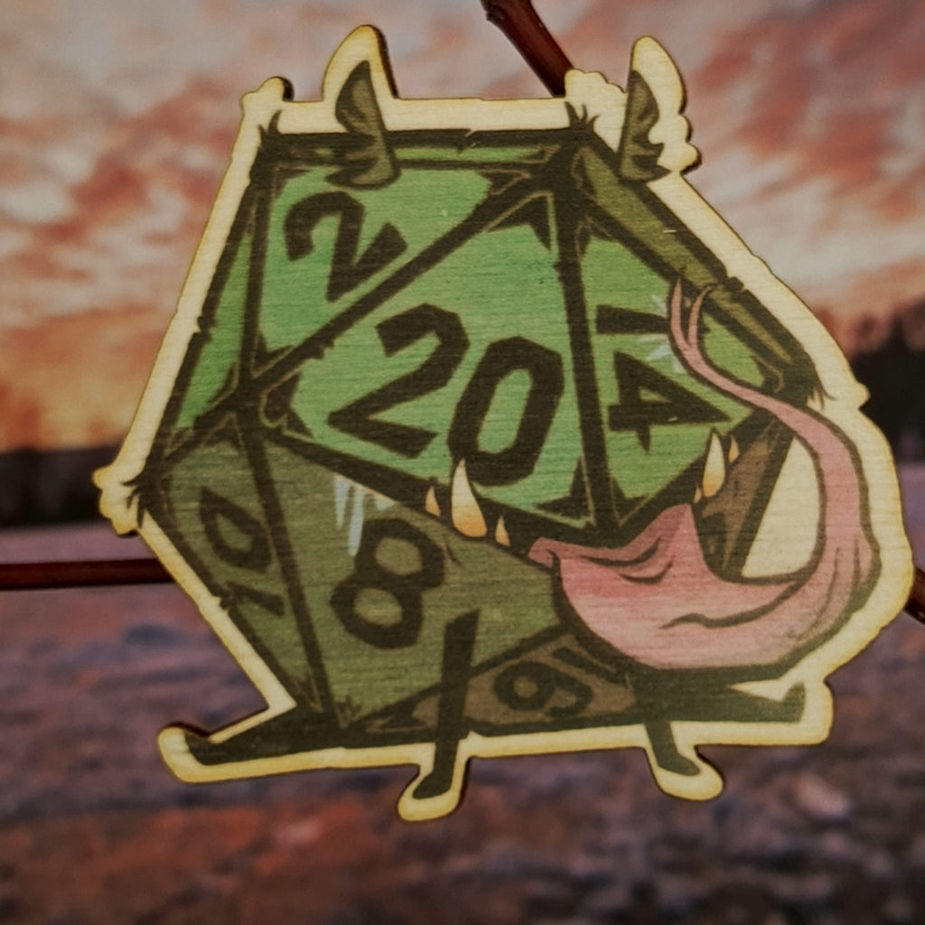 Brož s dvacetistěnným symbolem volby a náhody.