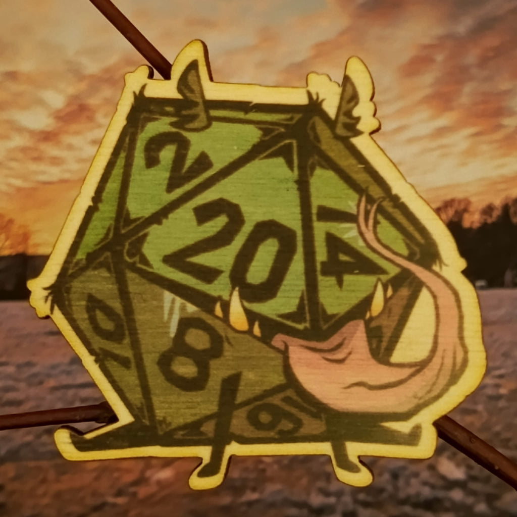 Brož s dvacetistěnným symbolem volby a náhody.